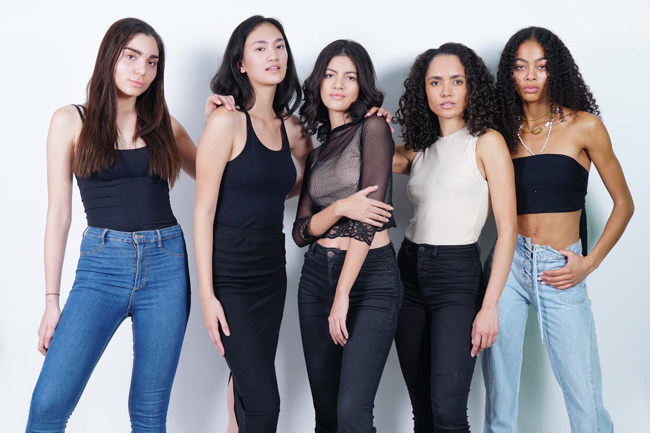 Mastering the First Impression: Your intriguing post title goes here Five young women posing in casual and fashionable outfits in a studio setting.